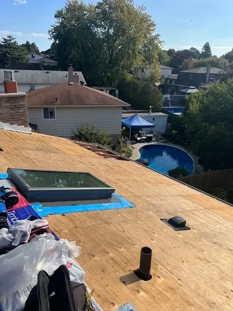 Flat roof re-deck with a new skylight